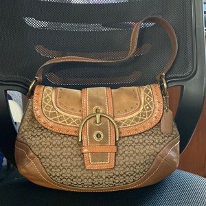 Coach bag, medium size brown color with signature fabric.